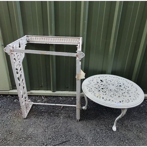 67 - A modern white painted metal Garden Table with pierced decoration on shaped supports and a white pai... 