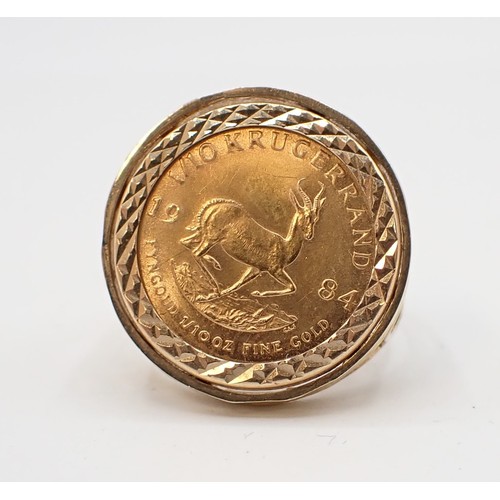 256 - A coin Ring set 1/10 Krugerrand 1984 in 9ct gold, ring size K, approx 6gms all in