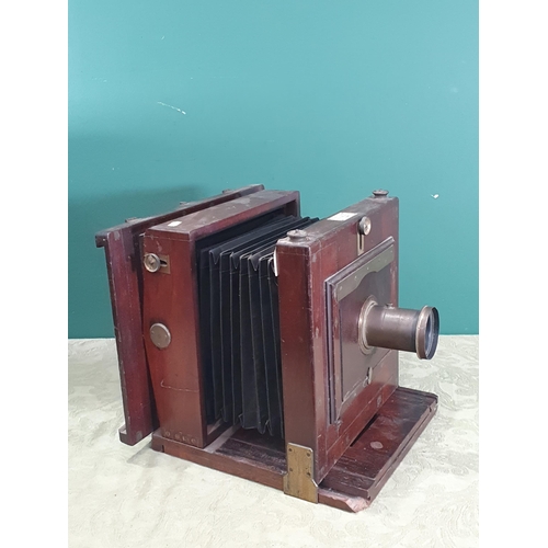 1371 - A mahogany 8 x 8in mahogany and brass mounted large format Camera with indistinctly signed lens, the... 