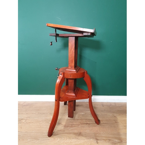 1382 - A late 19th Century mahogany Studio Camera stand, a rise, fall and tilting mechanism on shaped suppo... 