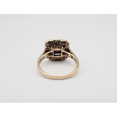 141 - An Art Deco style square Cluster Ring set central round garnet within pavé-set brilliant-cut diamond... 