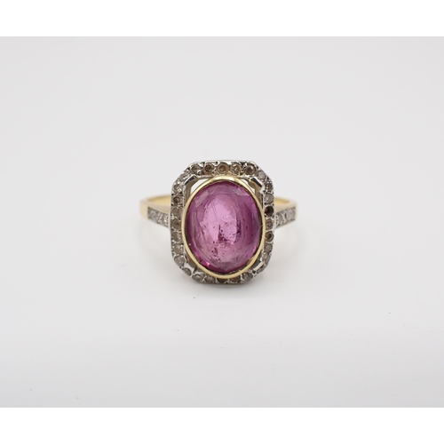 142 - A Pink Sapphire and Diamond Cluster Ring rubover-set oval-cut sapphire within a frame of eight-cut d... 