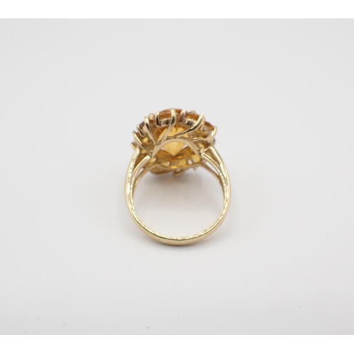 151 - A Madeira Citrine Cluster Ring claw-set mixed-cut oval stone within a frame of marquise-cut stones i... 