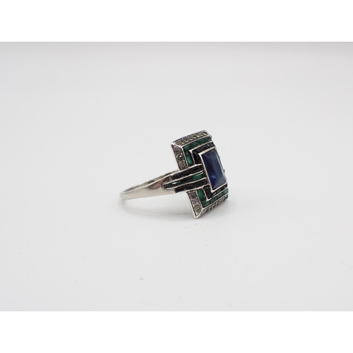 154 - An Art Deco Cocktail Ring millegrain-set blue, green and white paste to the rectangular plaque, in w... 