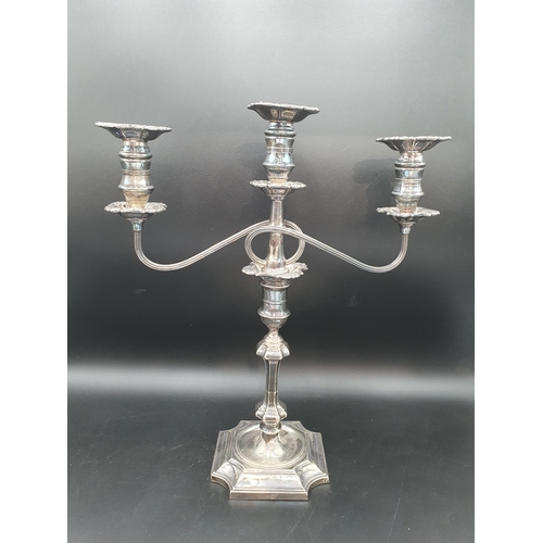 17 - A George V silver Candlestick having knop stem on square base with inverted corners engraved crest, ... 