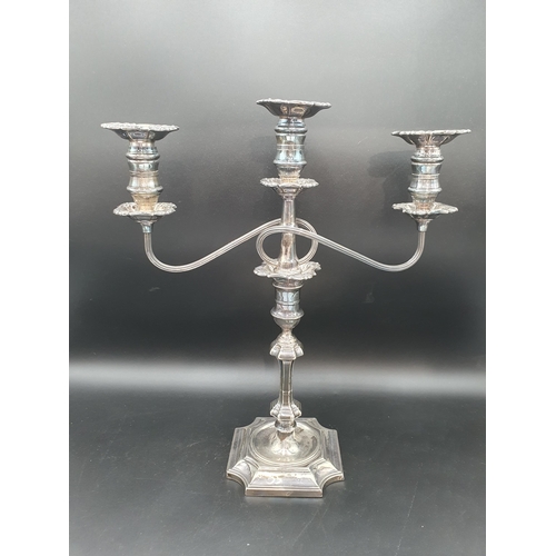 17 - A George V silver Candlestick having knop stem on square base with inverted corners engraved crest, ... 