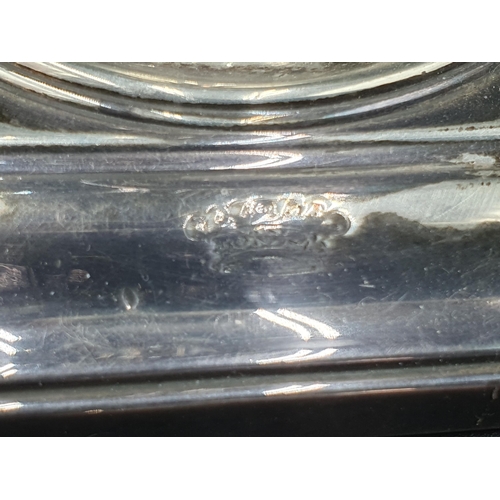 17 - A George V silver Candlestick having knop stem on square base with inverted corners engraved crest, ... 