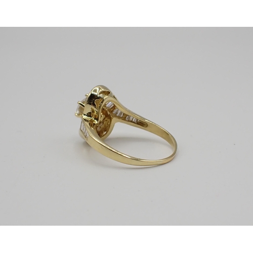 172 - A contemporary Diamond Crossover Ring claw-set brilliant-cut stone, 0.65cts, within frame of graduat... 