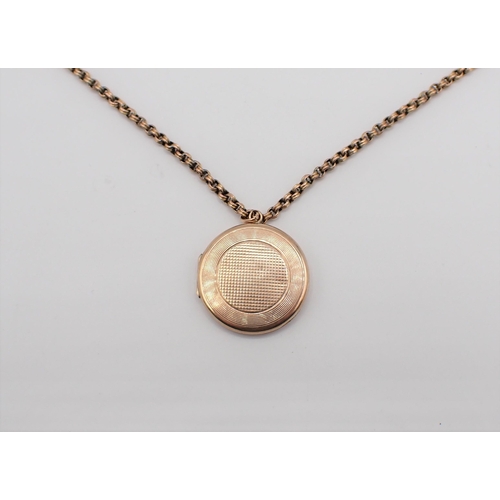 177 - A circular 9ct gold Locket with engine turning and monogram engraved to reverse on chain marked 9C, ... 