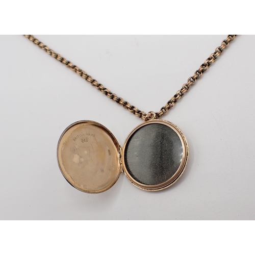 177 - A circular 9ct gold Locket with engine turning and monogram engraved to reverse on chain marked 9C, ... 