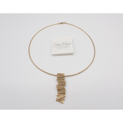 183 - A Sheila Fleet (Orkney Designer Jewellery) 9ct gold Torque Necklace with textured tile effect drop, ... 