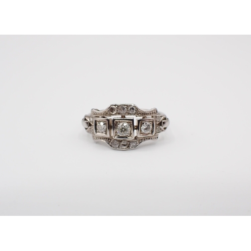 188 - An Art Deco style Diamond Ring pavé-set three graduated principle old and brilliant-cut stones withi... 