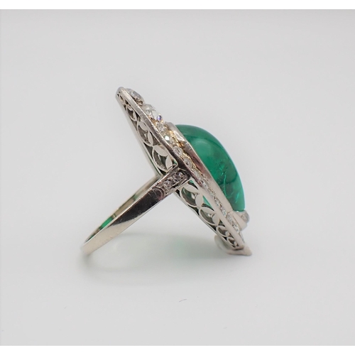 201 - A mid 20th Century Emerald and Diamond Cocktail Ring set irregular shaped emerald cabochon within mi... 