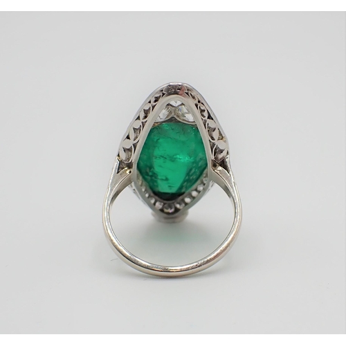 201 - A mid 20th Century Emerald and Diamond Cocktail Ring set irregular shaped emerald cabochon within mi... 