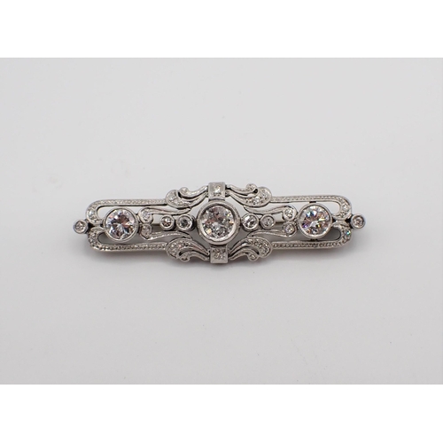 206 - An Art Deco style Diamond Brooch millegrain-set throughout brilliant and eight-cut stones in 14ct wh... 