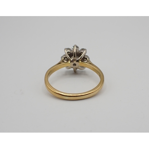 212 - A Diamond flower Cluster Ring claw-set brilliant-cut stone within frame of eight smaller stones in 1... 