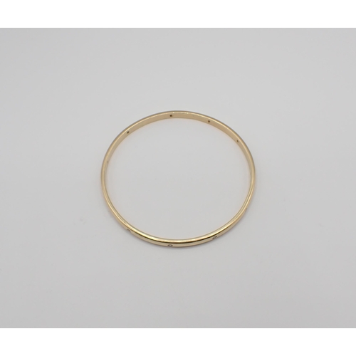 214 - A Diamond Bangle gypsy-set eleven brilliant-cut stones in gold, unmarked, untested, approx 20gms