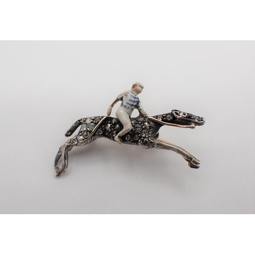 222 - A Diamond and Enamel Horse and Jockey Brooch the jockey enamelled with blue and white hooped colours... 