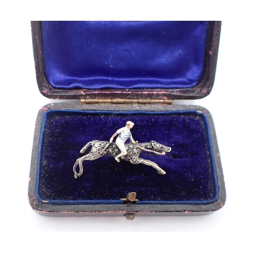 222 - A Diamond and Enamel Horse and Jockey Brooch the jockey enamelled with blue and white hooped colours... 