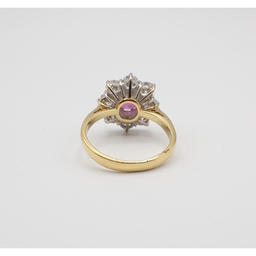 224 - A Ruby and Diamond flower Cluster Ring claw-set round ruby within a frame of eight brilliant-cut dia... 