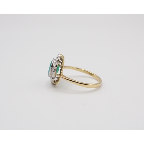 225 - An Emerald and Diamond Cluster Ring millegrain-set oval-cut emerald within a frame of baguette and b... 