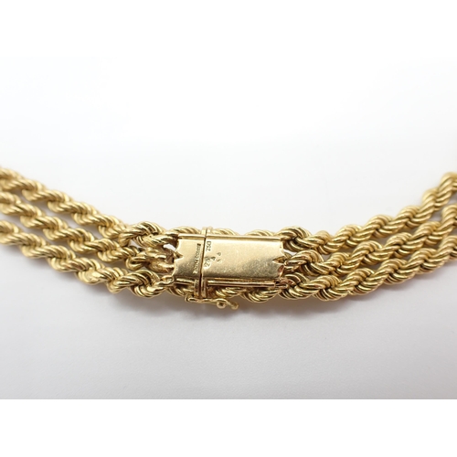 226 - A Swiss 18ct gold Tassel Necklace comprised of three rope twist strands, approx 41cms long excluding... 