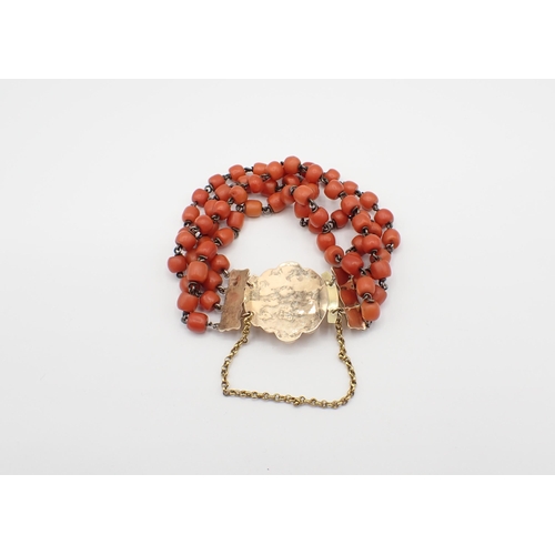 228 - A four strand Coral bead Bracelet on gold rosette clasp, approx 28.90gms total weight