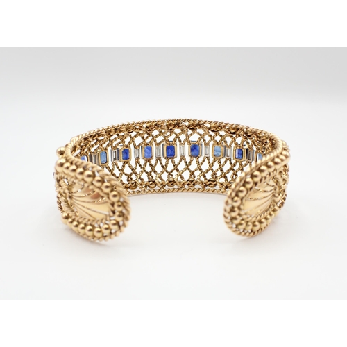 229 - A Gubelin Sapphire and Diamond Bangle of graduated bombé form corner claw-set a row of graduated ste... 