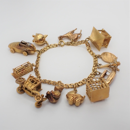 230 - A fancy link 18ct gold Bracelet suspending approx twelve charms, some 9ct some 18ct gold, approx 36g... 