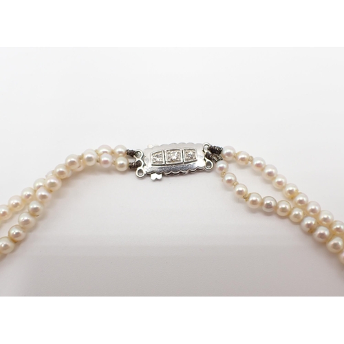 236 - A double row of graduated Cultured Pearls on 18ct white gold clasp pavé-set three brilliant-cut diam... 