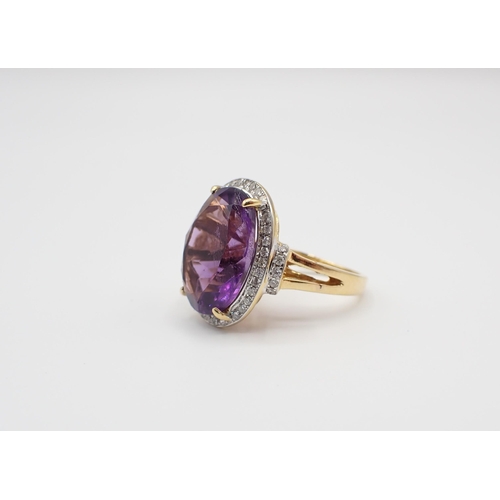 239 - An Amethyst and Diamond Cluster Ring claw-set oval-cut amethyst within a frame of pavé-set brilliant... 