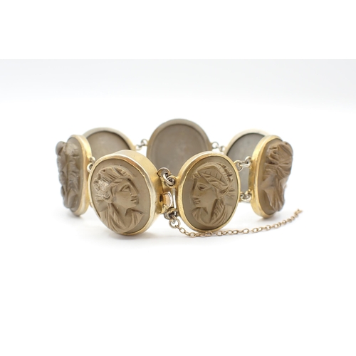 243 - A Lava Cameo Bracelet the seven graduated links each carved bust in profile in gilt metal