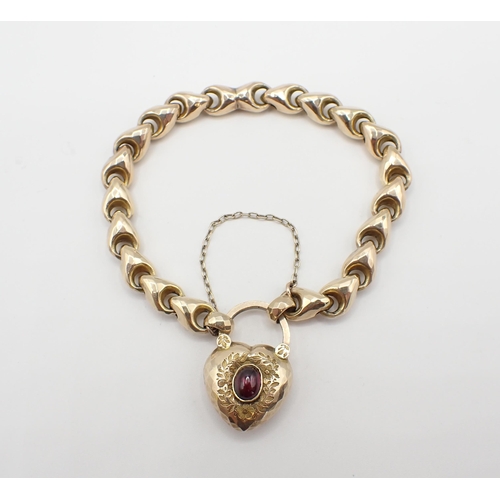 254 - A faceted hollow link gold Bracelet on floral engraved padlock fastener set almandine garnet, enclos... 