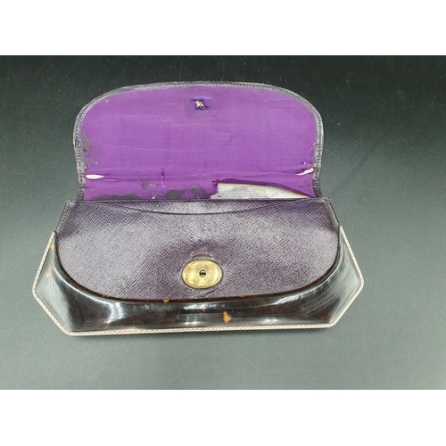 271 - A tortoiseshell and leather Evening Purse with white metal mounts and floral cabochon clasp