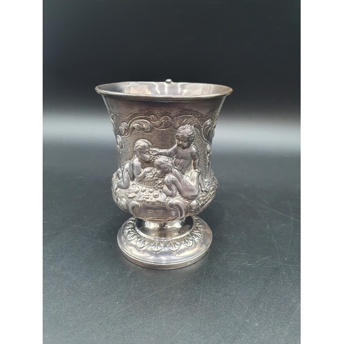 32 - A George IV silver Mug finely embossed cherubs, fruiting vines, flowers and scrolls on pedestal base... 