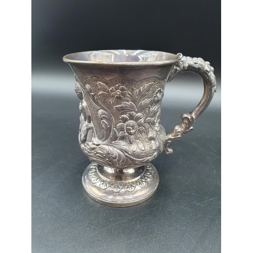 32 - A George IV silver Mug finely embossed cherubs, fruiting vines, flowers and scrolls on pedestal base... 