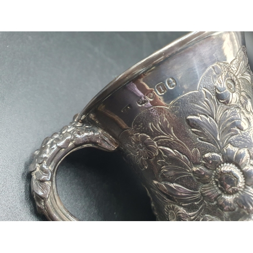 32 - A George IV silver Mug finely embossed cherubs, fruiting vines, flowers and scrolls on pedestal base... 