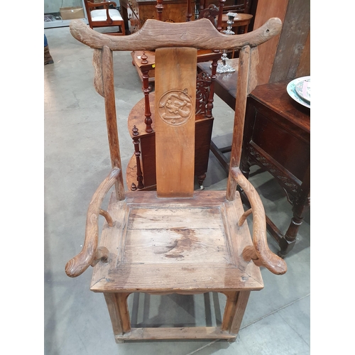 345 - A pair of Chinese yoke-back elm Chairs, the shaped splats with carved roundels and shaped arms, 3ft ... 