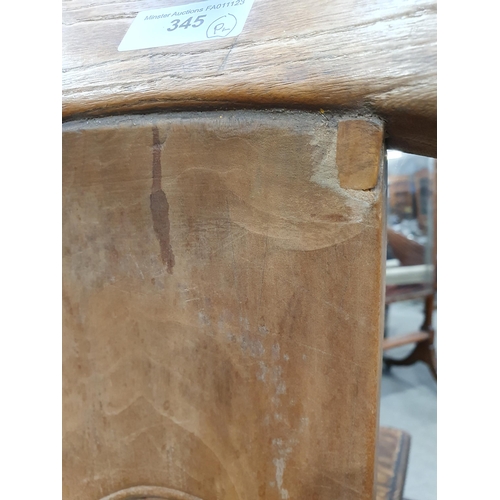 345 - A pair of Chinese yoke-back elm Chairs, the shaped splats with carved roundels and shaped arms, 3ft ... 