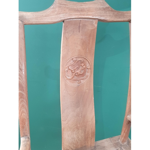 345 - A pair of Chinese yoke-back elm Chairs, the shaped splats with carved roundels and shaped arms, 3ft ... 