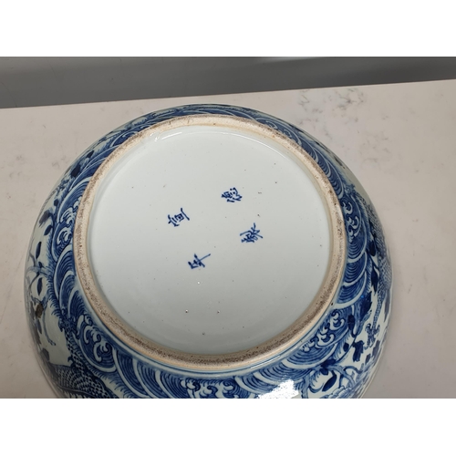 351 - A 19th Century Chinese large blue and white Bowl decorated dragons and flowers in a landscape with i... 