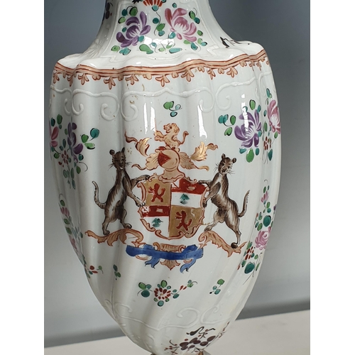 361 - A pair of Chinese armorial Vases and Covers of spiral moulding and decorated sprays of flowers on pe... 