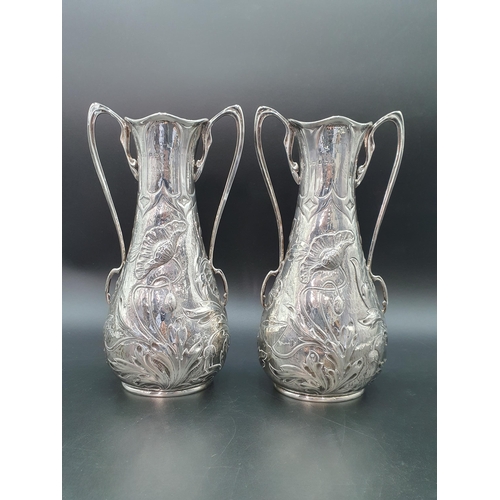 38 - A pair of Edward VII Art Nouveau silver two handled Vases finely embossed poppies, Birmingham 1903, ... 