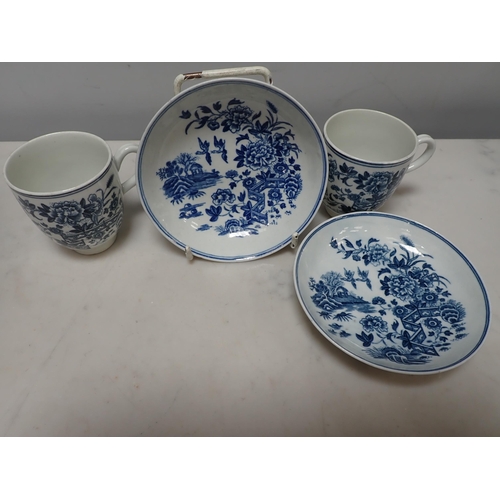 382 - A pair of early Worcester blue and white Cups and Saucers with fence pattern, crescent mark