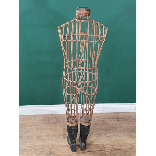 410 - An antique child size Dressmaker's Mannequin with open wicker body and wooden lower legs and boots (... 