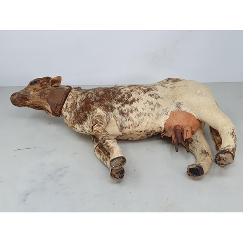 414 - An antique Folk Art skin covered wooden Model of a Shorthorn Cow with glass eyes A/F 14in L, and ano... 