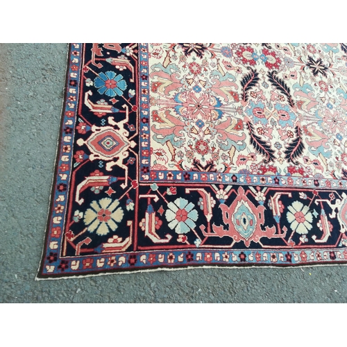 417 - A large modern Carpet with leafage design on cream ground within blue border 13ft 1in L x 10ft 4in W