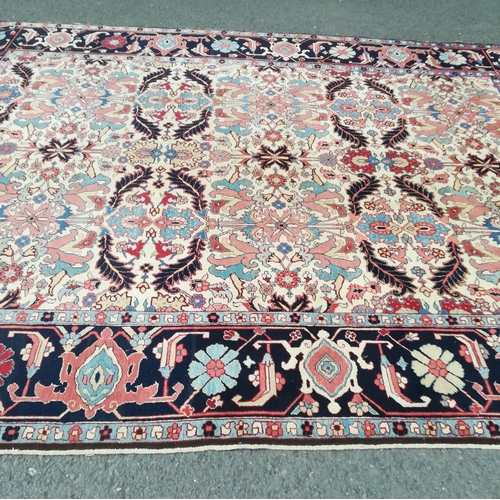 417 - A large modern Carpet with leafage design on cream ground within blue border 13ft 1in L x 10ft 4in W