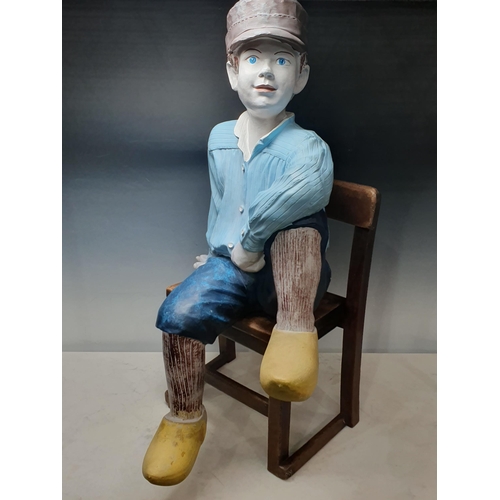 427 - A painted fibreglass Figure of a boy in clogs 2ft 7in H