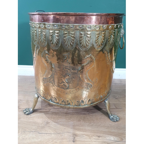 435 - A Victorian brass and copper Log Cauldron with lion mask ring handles, with embossed coats of arms o... 